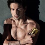 Model Holding the Invictus Elixir Parfum Elixir bottle by Rabanne